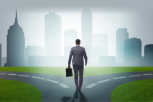 businessman standing at a crossroads, making a difficult decision